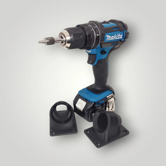 A blue and black Makita cordless power drill stands upright with two black attachments on a light gray background—ideal for use with the Wandhalter für Makita Akkuschrauber 18V in your workshop.